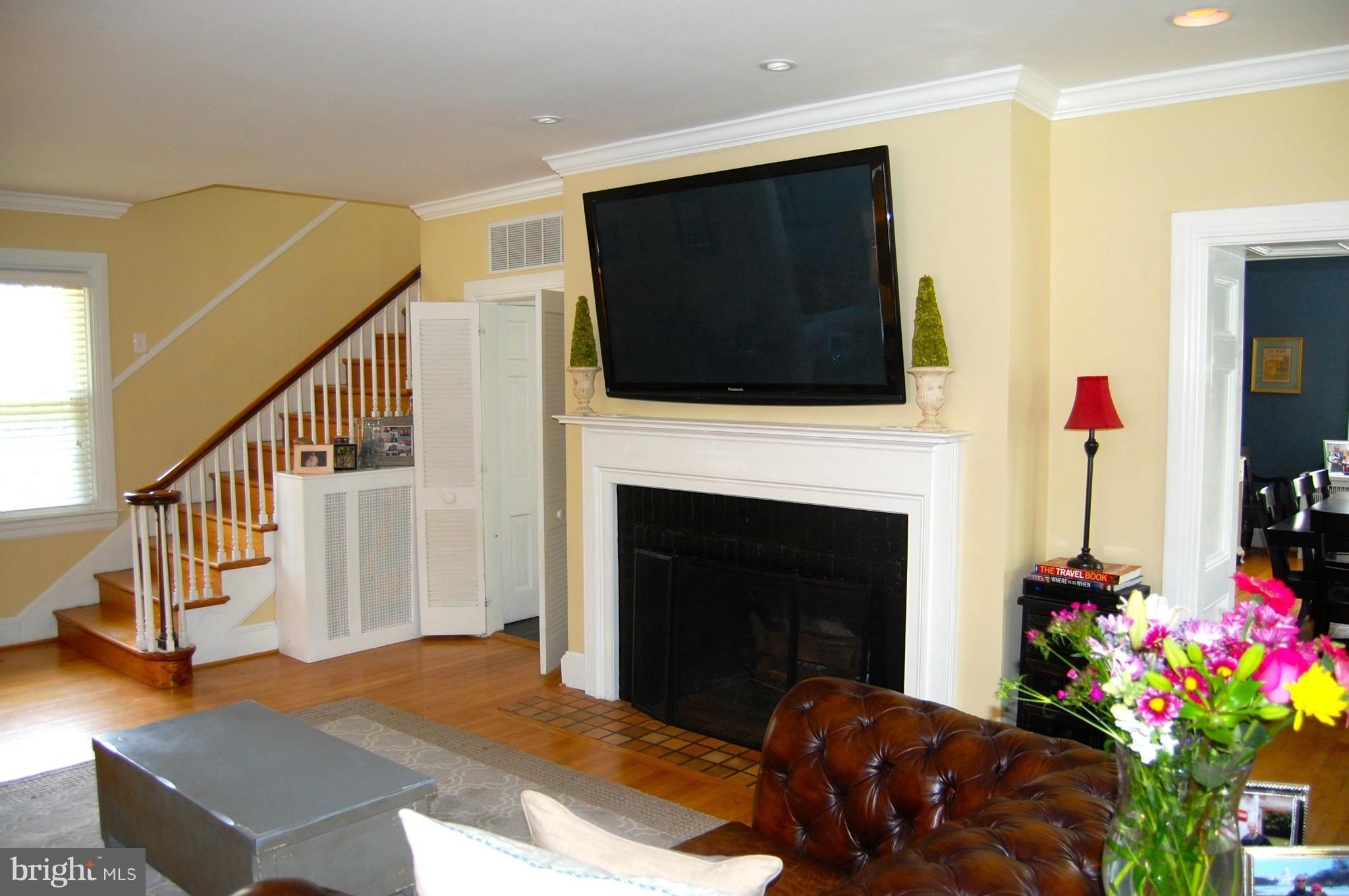 345 Tunbridge Road Baltimore, MD 21212 - Photo 4 of 30 a living room with furniture a flat screen tv and a fireplace