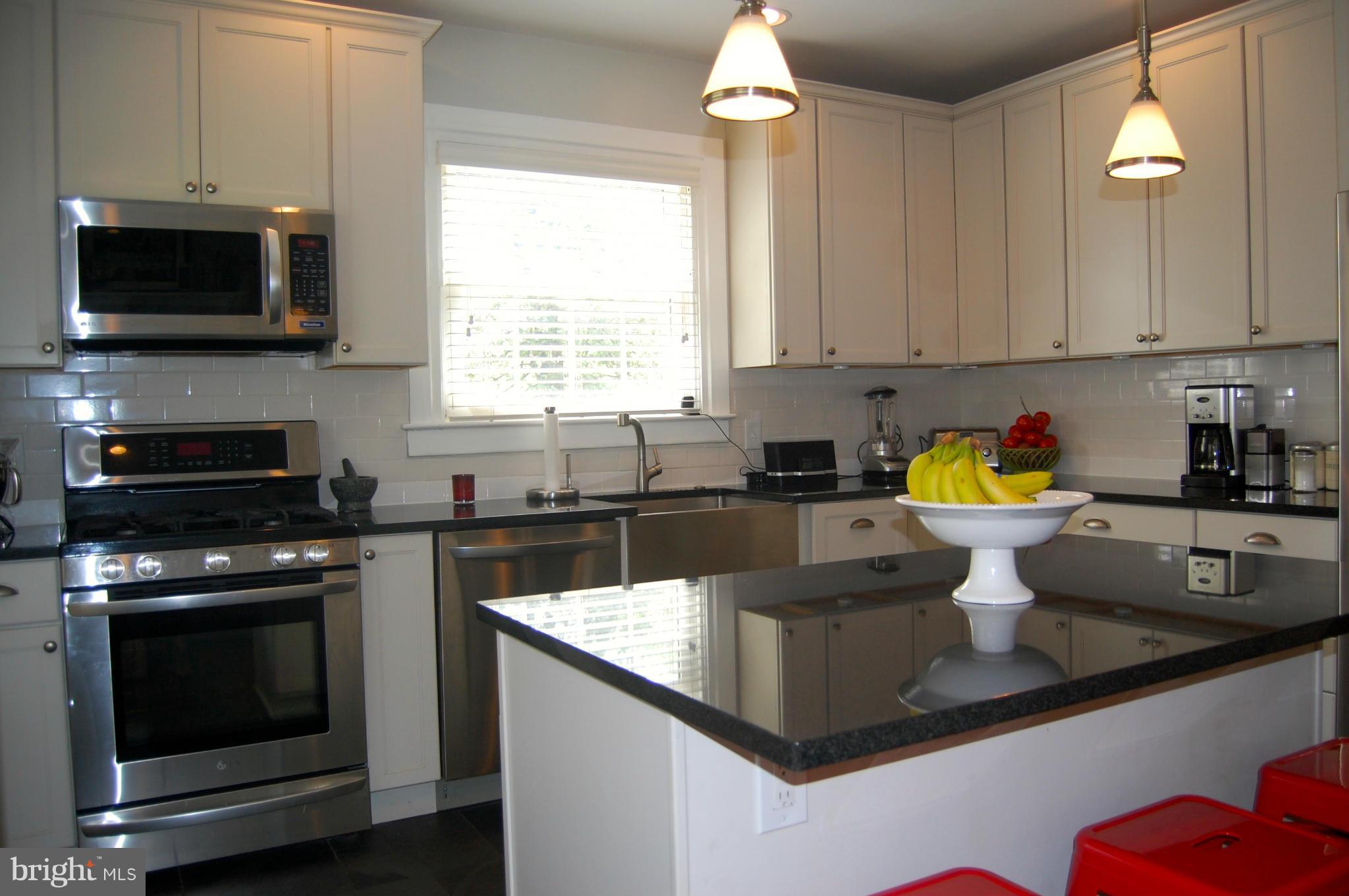 345 Tunbridge Road Baltimore, MD 21212 - Photo 9 of 30 a kitchen with a sink a stove and microwave
