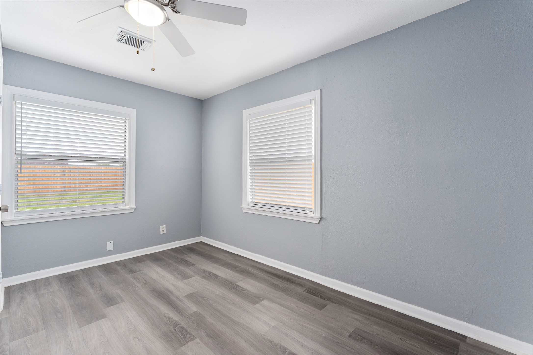 5703 Minden Street Houston, TX 77026 - Photo 12 of 20 wooden floor in an empty room with a window