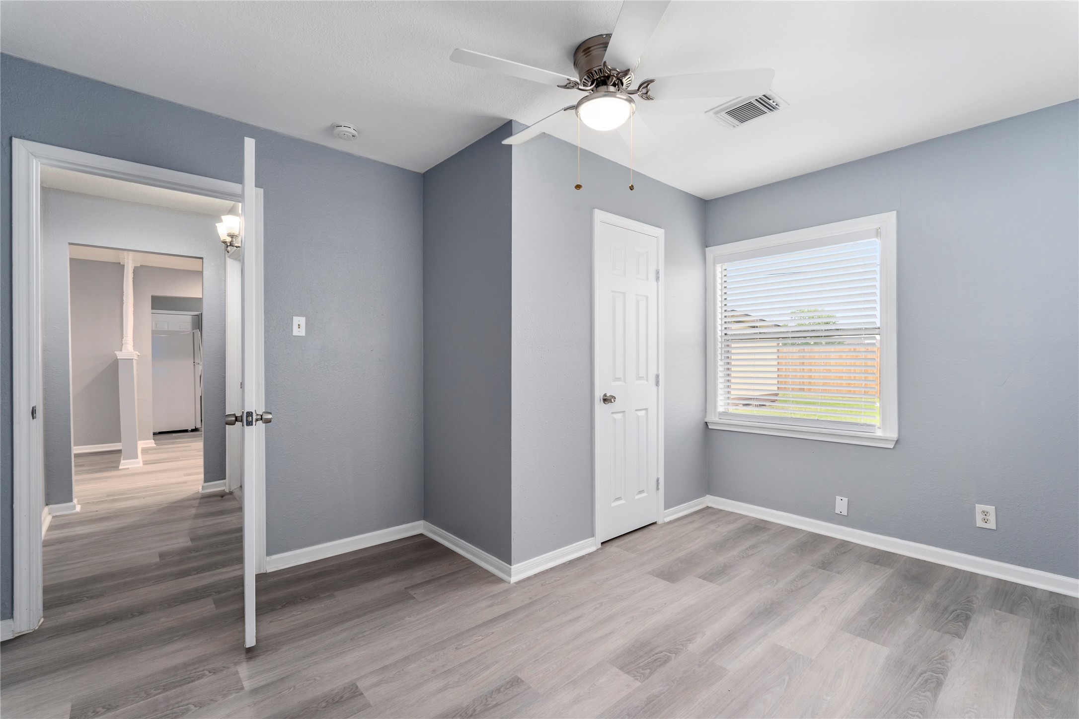 5703 Minden Street Houston, TX 77026 - Photo 13 of 20 a view of empty room with wooden floor and fan