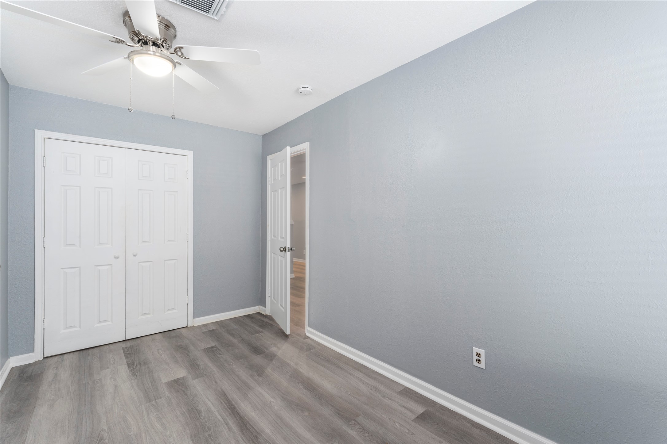 5703 Minden Street Houston, TX 77026 - Photo 14 of 20 an empty room with a ceiling fan and carpet