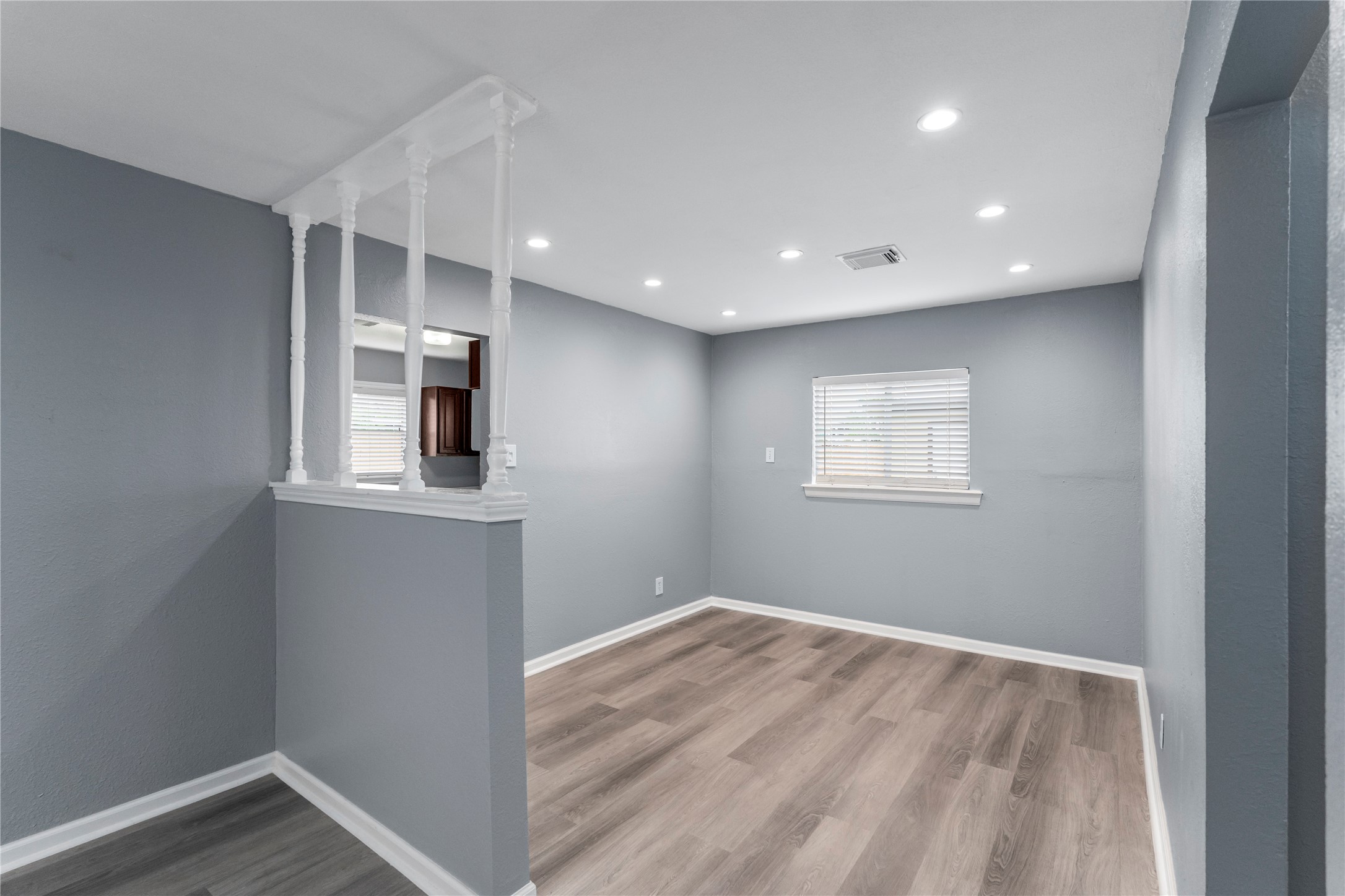 5703 Minden Street Houston, TX 77026 - Photo 5 of 20 a view of empty room with wooden floor and fan