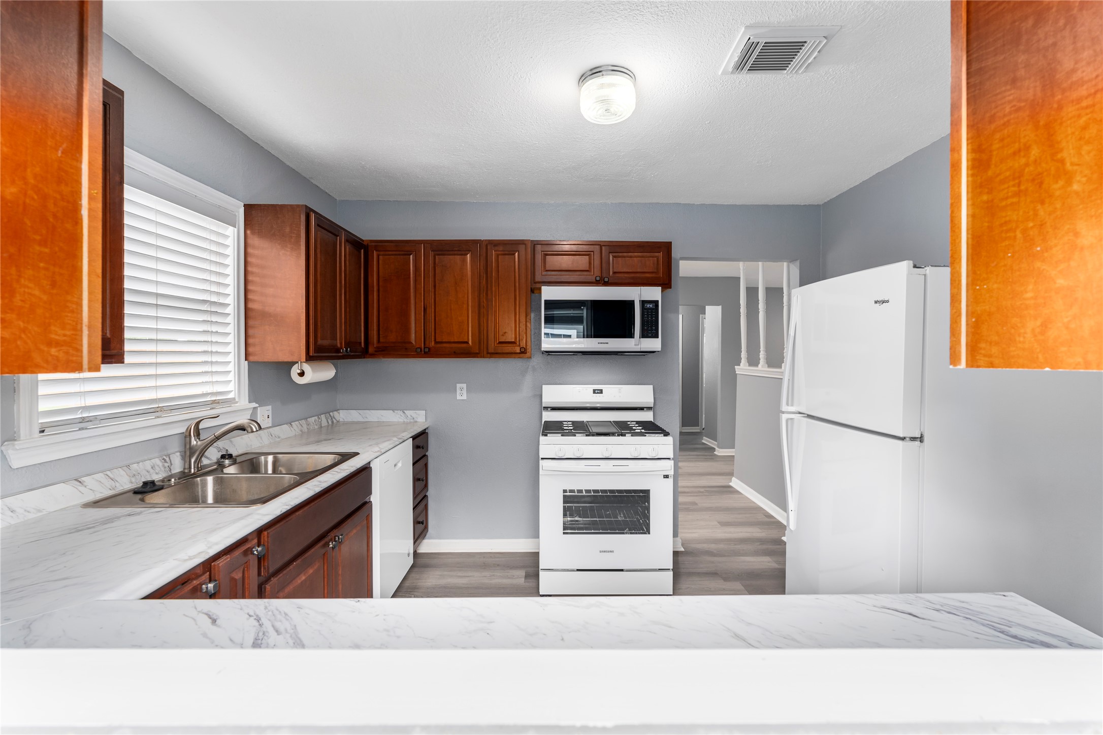 5703 Minden Street Houston, TX 77026 - Photo 7 of 20 a kitchen with stainless steel appliances a stove a sink and a refrigerator