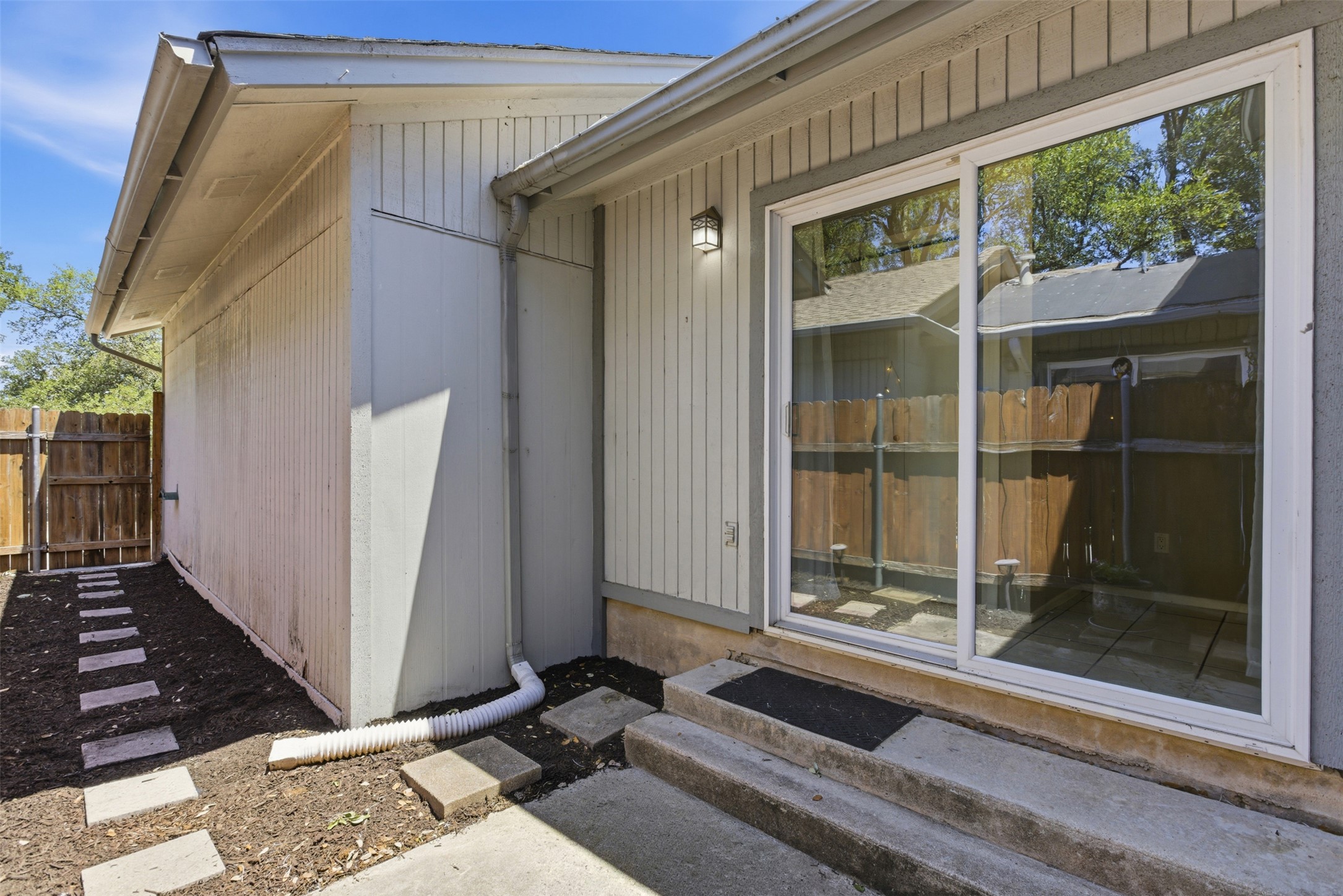 4204 Hudson Bend Road, Unit B Austin, TX 78734 - Photo 23 of 37 Sliding glass door opening to an outdoor area with concrete steps