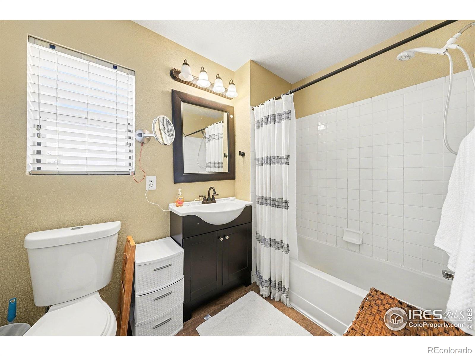 6815 Autumn Ridge Drive Fort Collins, CO 80525 - Photo 12 of 23 a bathroom with a sink a toilet and shower