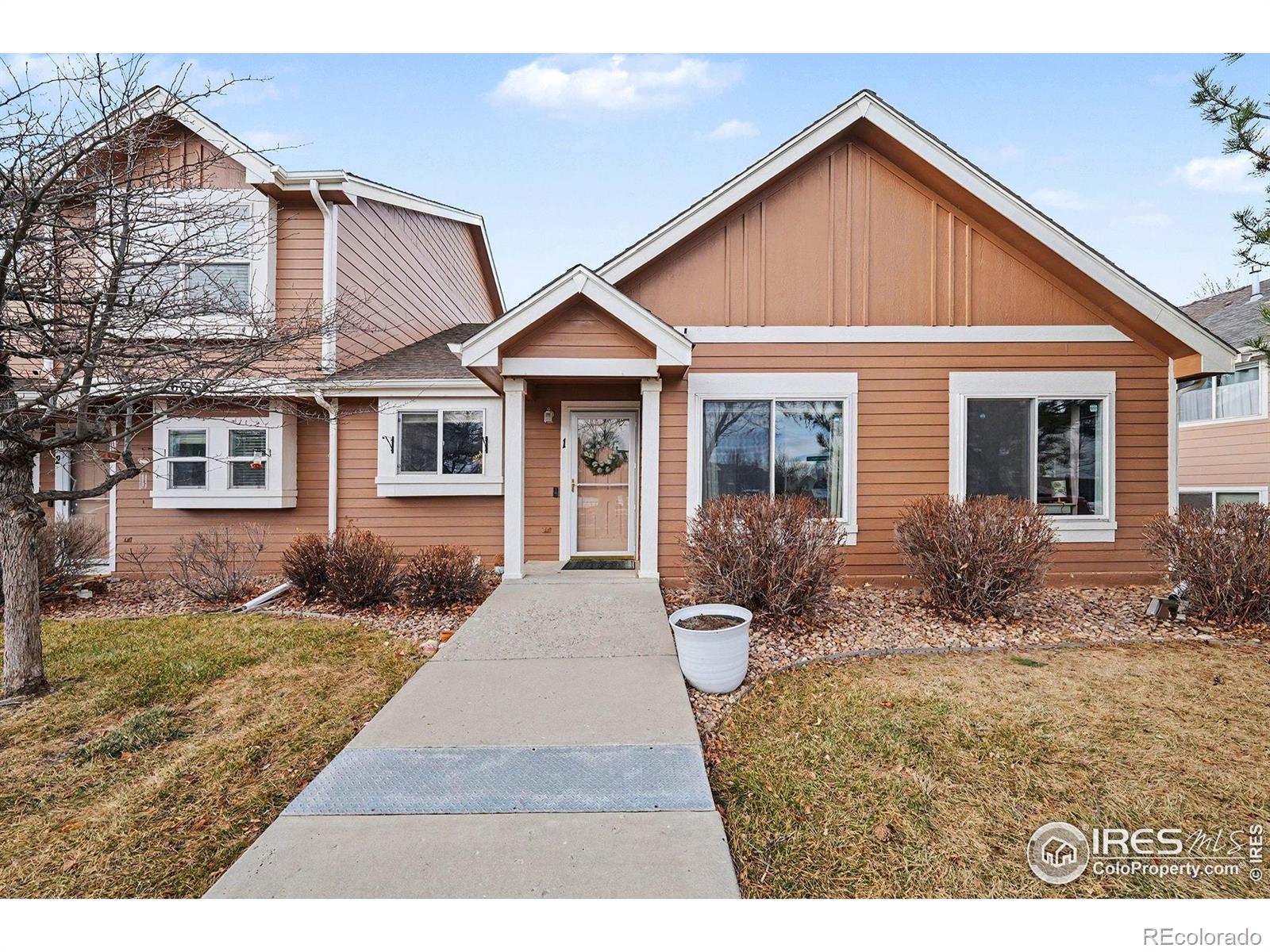 6815 Autumn Ridge Drive Fort Collins, CO 80525 - Photo 16 of 23 a front view of a house with a yard