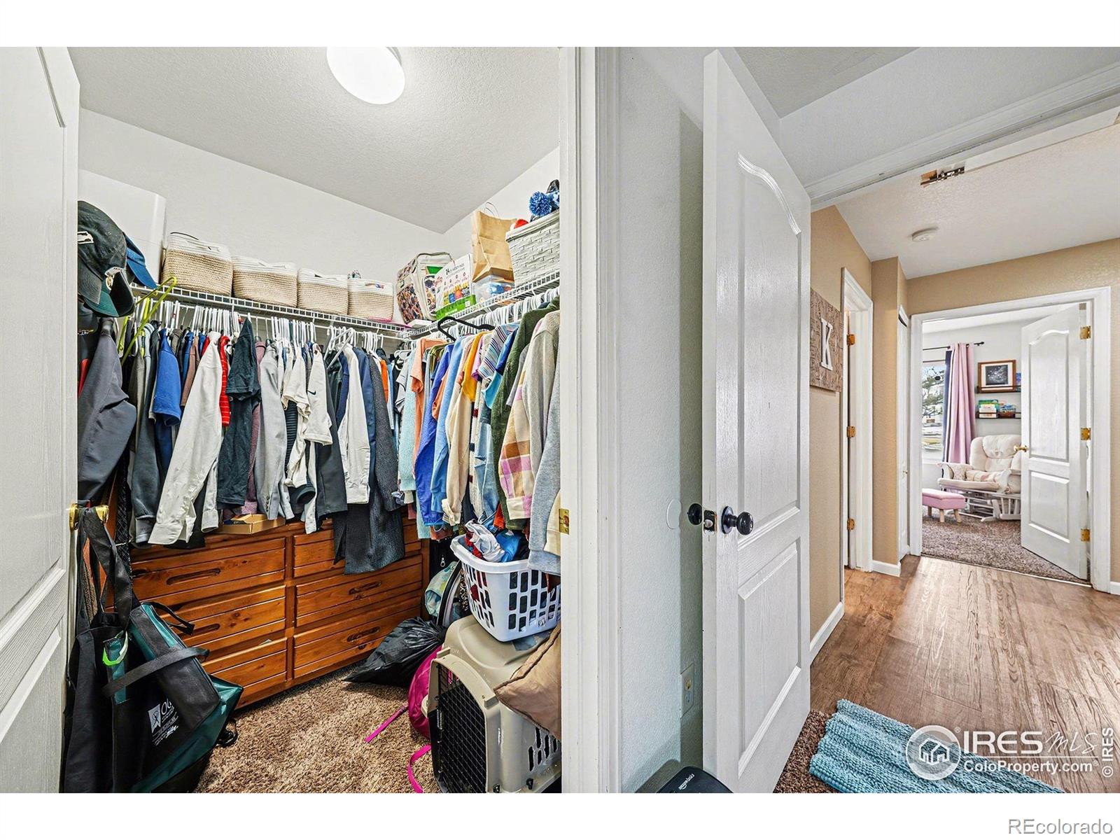 6815 Autumn Ridge Drive Fort Collins, CO 80525 - Photo 20 of 23 a view of a hallway with wooden floor and furniture