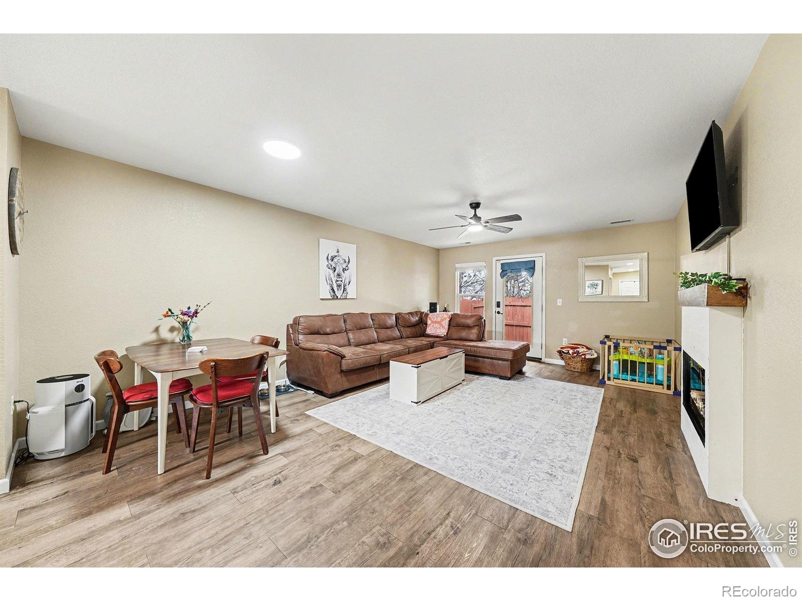 6815 Autumn Ridge Drive Fort Collins, CO 80525 - Photo 2 of 23 a living room with furniture and a flat screen tv