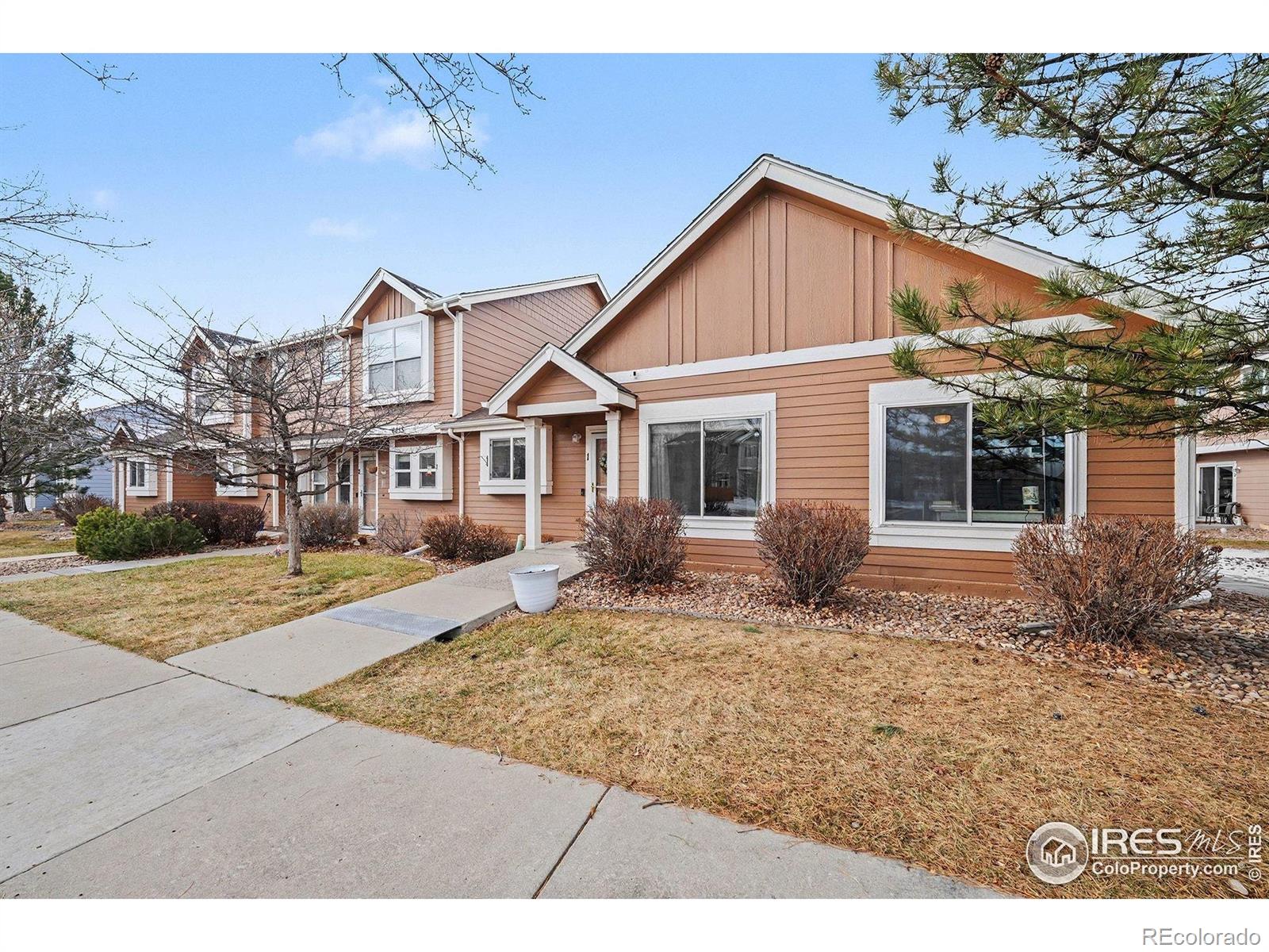 6815 Autumn Ridge Drive Fort Collins, CO 80525 - Photo 22 of 23 a front view of a house with garden