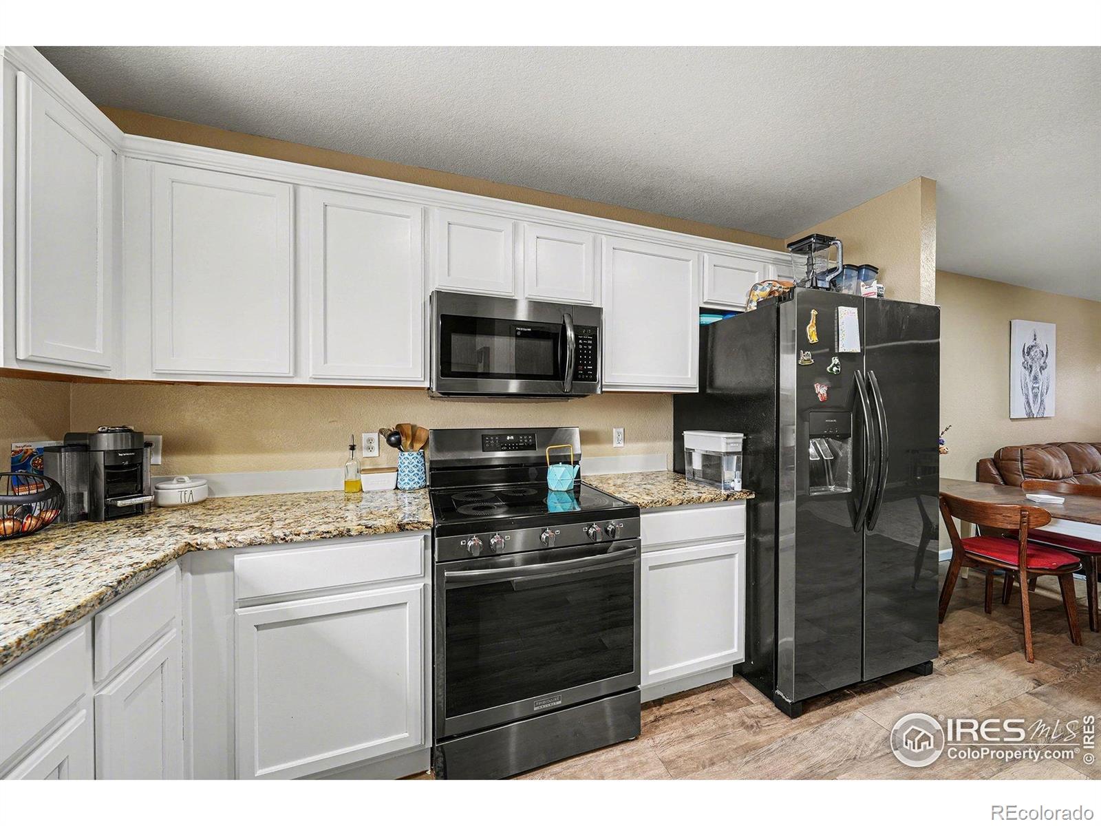 6815 Autumn Ridge Drive Fort Collins, CO 80525 - Photo 4 of 23 a kitchen with a sink appliances and cabinets