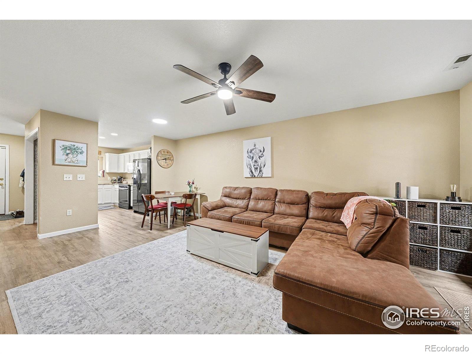 6815 Autumn Ridge Drive Fort Collins, CO 80525 - Photo 5 of 23 a living room with furniture a ceiling fan and a rug