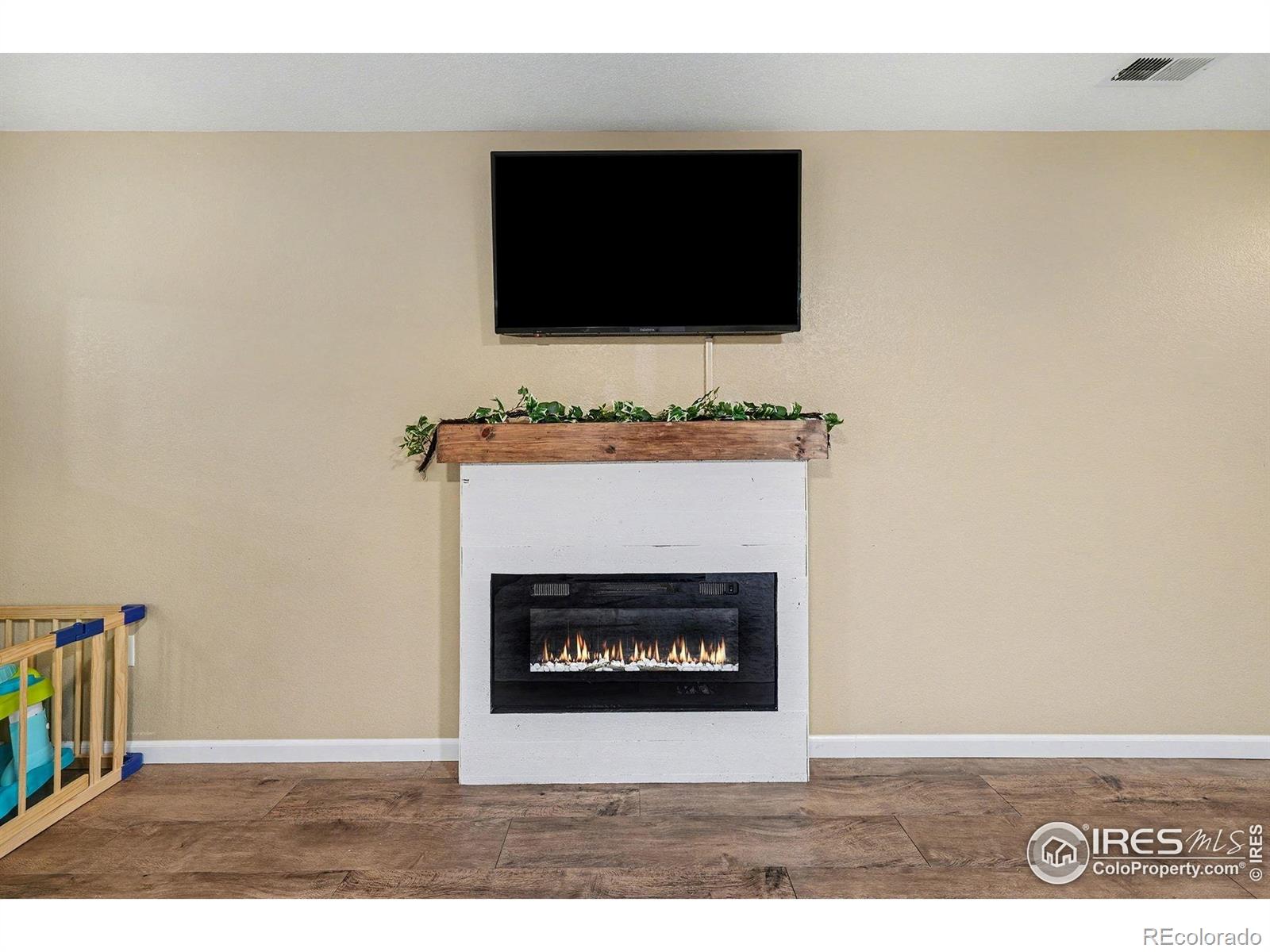 6815 Autumn Ridge Drive Fort Collins, CO 80525 - Photo 6 of 23 a living room with a fireplace and a flat screen tv