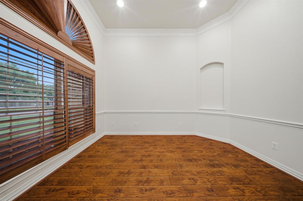 603 Cedar Drive Pilot Point, TX 76258 - Photo 13 of 39 Spacious office or living room featuring wood-finish flooring, white walls with wainscoting, crown molding, and recessed lighting