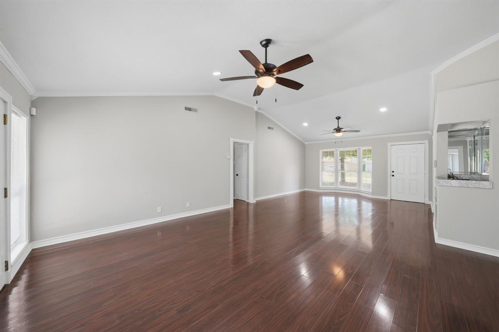 1108 Billie Ruth Lane Hurst, TX 76053 - Photo 7 of 27 Spacious living area featuring rich wood-finish flooring, vaulted ceilings, and recessed lighting