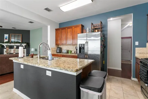 a kitchen with stainless steel appliances granite countertop a sink stove and refrigerator