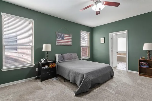 a bedroom with a bed and a dresser in it