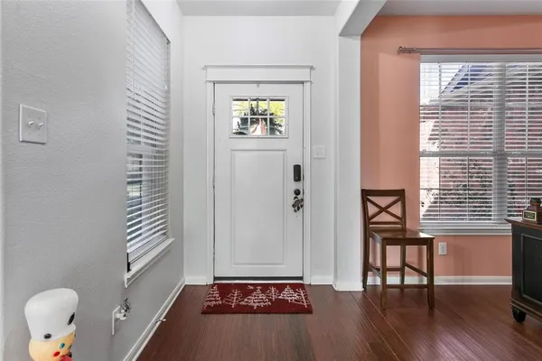 a view of an entryway with wooden floor and a window