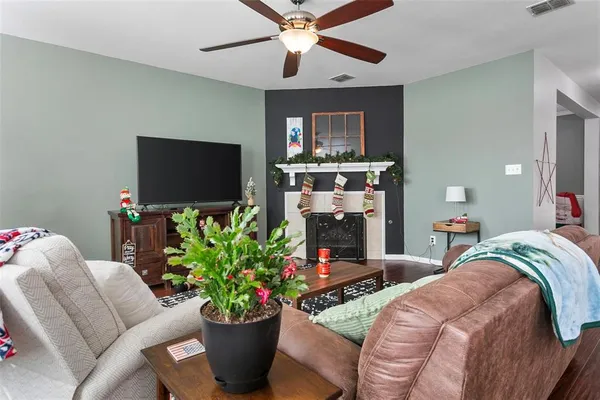 a living room with furniture a fireplace and a flat screen tv