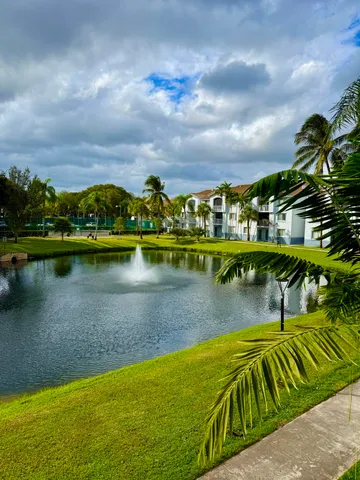 a view of swimming pool with a garden and outdoor seating