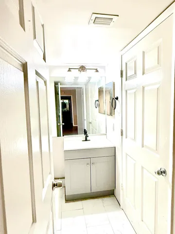 a bathroom with a sink a mirror and a shower