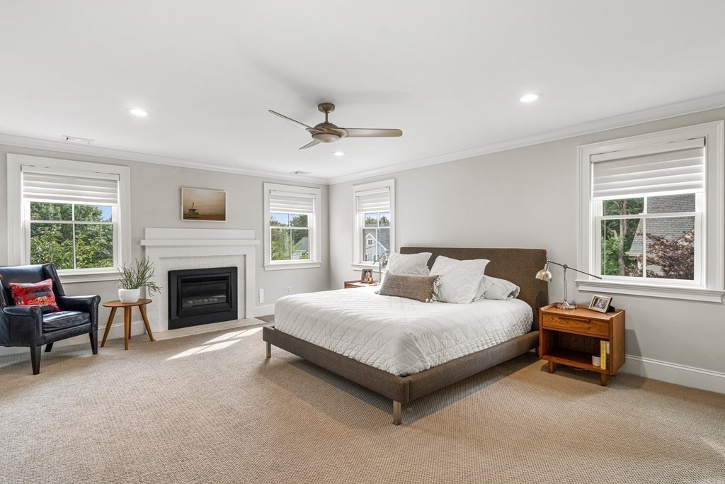 45 Bancroft Street Needham, MA 02492 - Photo 12 of 24 a spacious bedroom with a bed and a fireplace