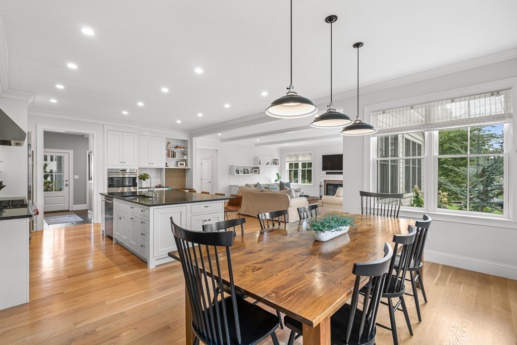 45 Bancroft Street Needham, MA 02492 - Photo 5 of 24 a view of a dining room and livingroom with furniture wooden floor a chandelier