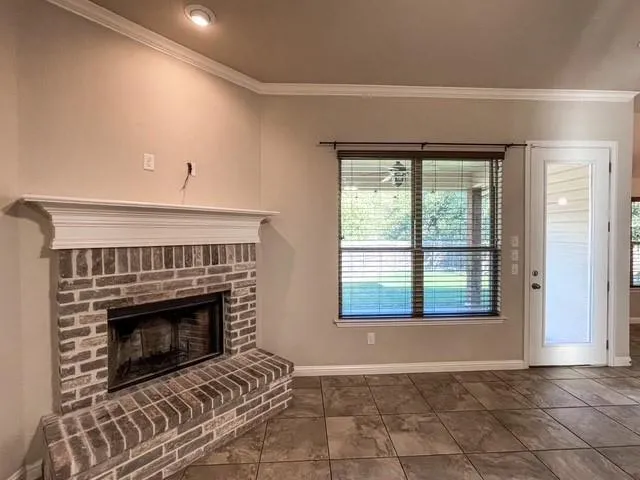 a living room with a fireplace and a floor to ceiling window