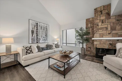 a living room with furniture a fireplace and a table