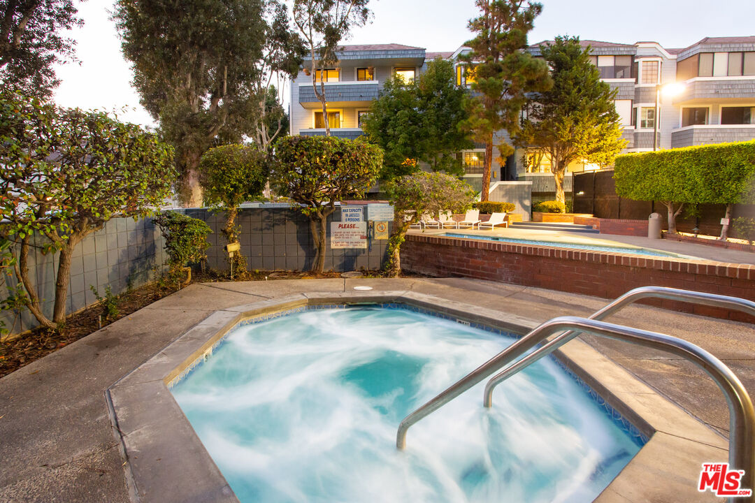 311 Bora Bora Way, Unit 3207 Marina del Rey, CA 90292 - Photo 52 of 54 a view of a swimming pool with a bench and trees around