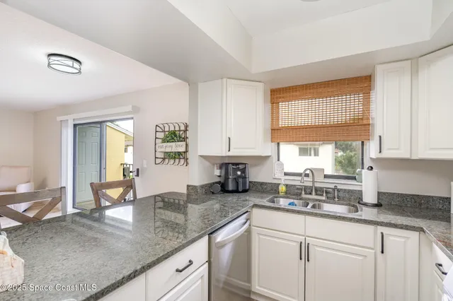a kitchen with granite countertop a sink and a window