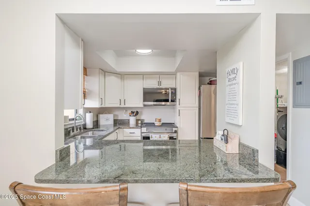a kitchen with kitchen island a sink a counter top space and appliances