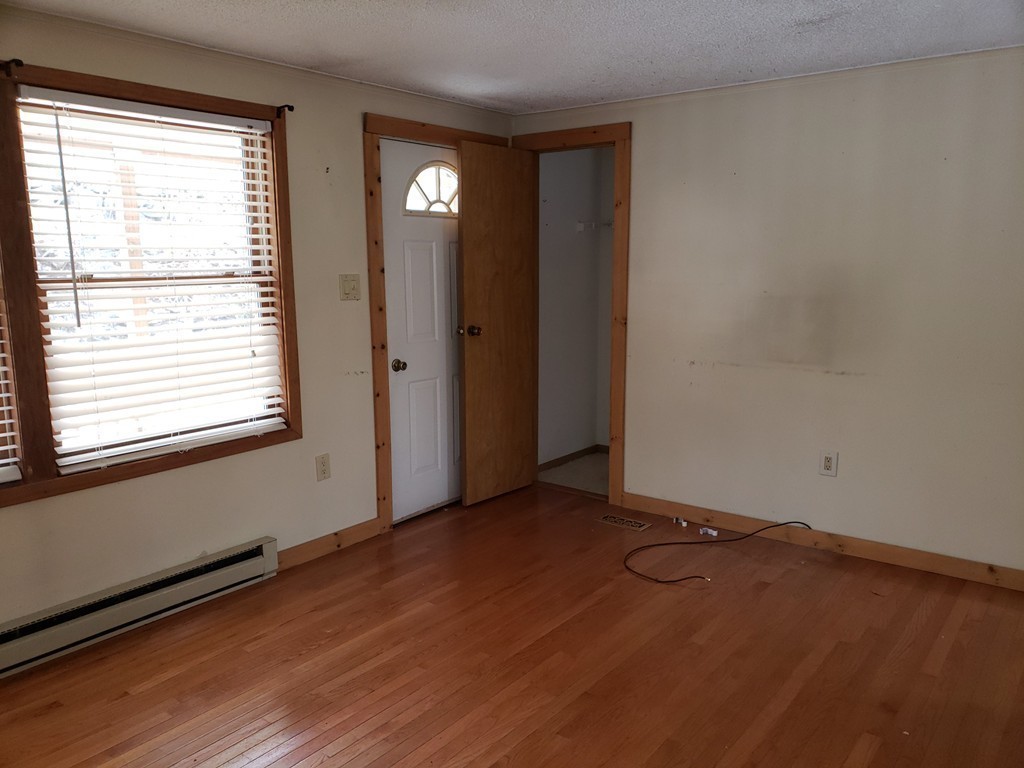 60 Haggerty Road Charlton, MA 01507 - Photo 12 of 28 an empty room with wooden floor and windows
