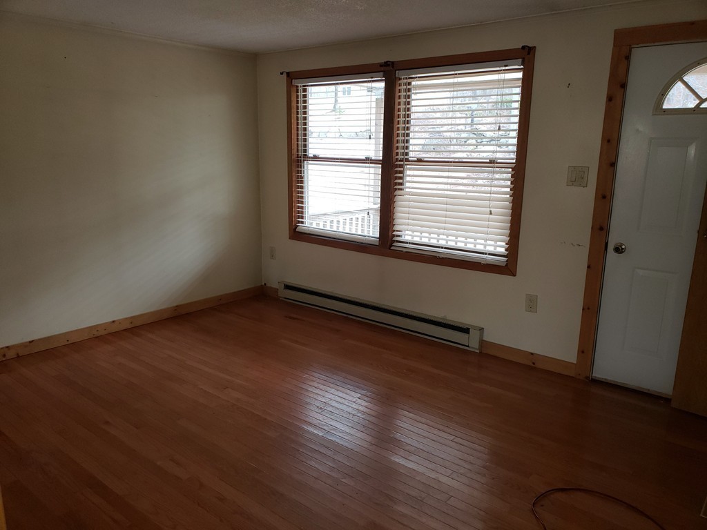 60 Haggerty Road Charlton, MA 01507 - Photo 13 of 28 a view of an empty room with wooden floor and a window