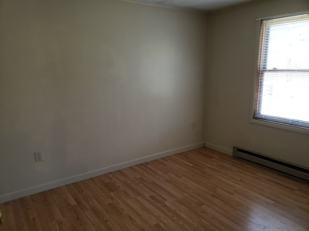 60 Haggerty Road Charlton, MA 01507 - Photo 16 of 28 an empty room with wooden floor and windows