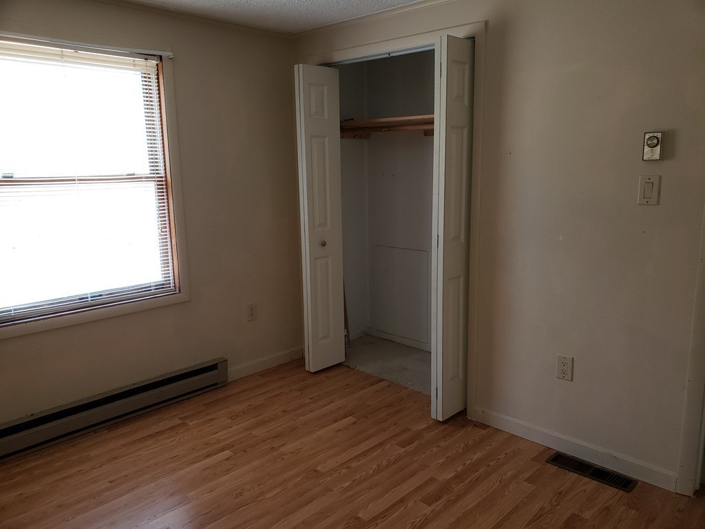 60 Haggerty Road Charlton, MA 01507 - Photo 17 of 28 an empty room with wooden floor closet and windows