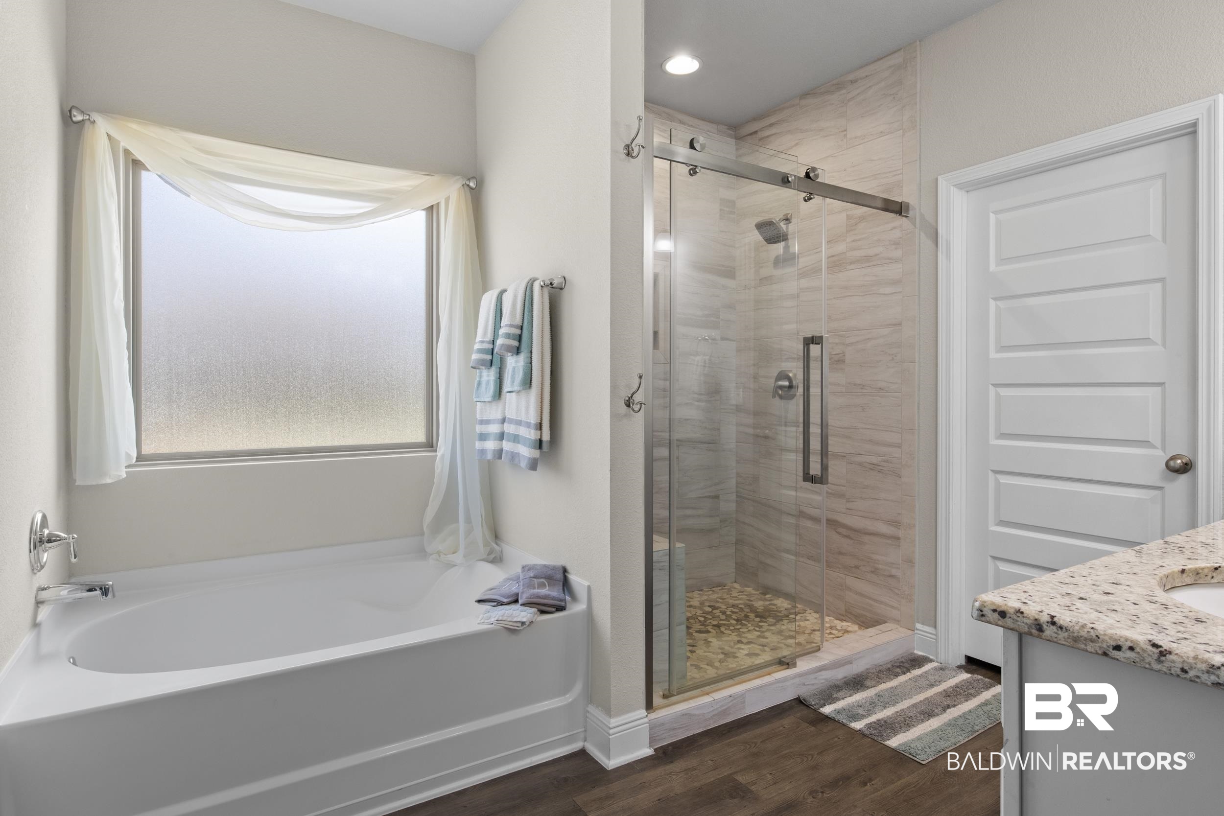 2050 Bourbon Street Foley, AL 36535 - Photo 19 of 32 Bathroom featuring separate shower and tub, hardwood / wood-style floors, and vanity