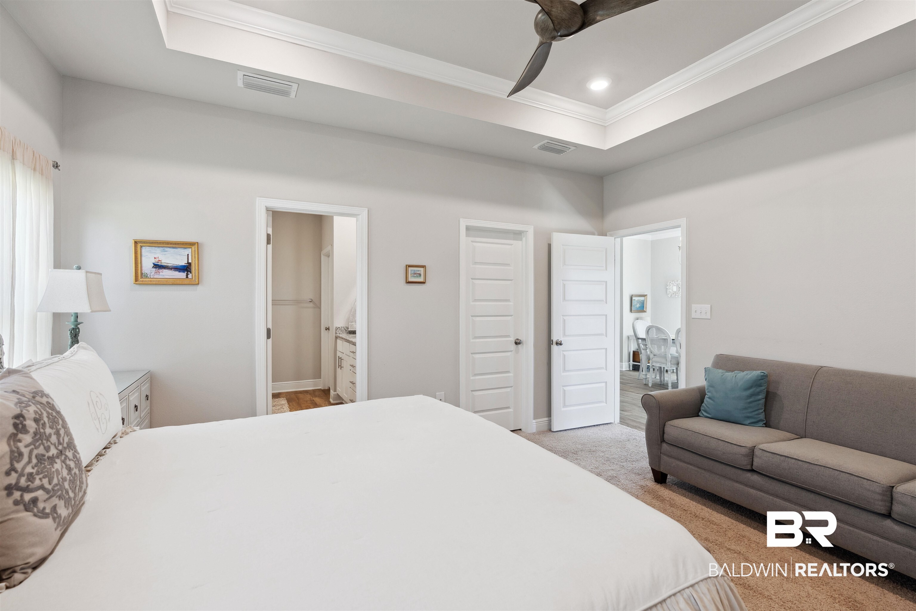 23809 Devonfield Lane Daphne, AL 36526 - Photo 17 of 29 Bedroom featuring a tray ceiling, light colored carpet, visible vents, and crown molding