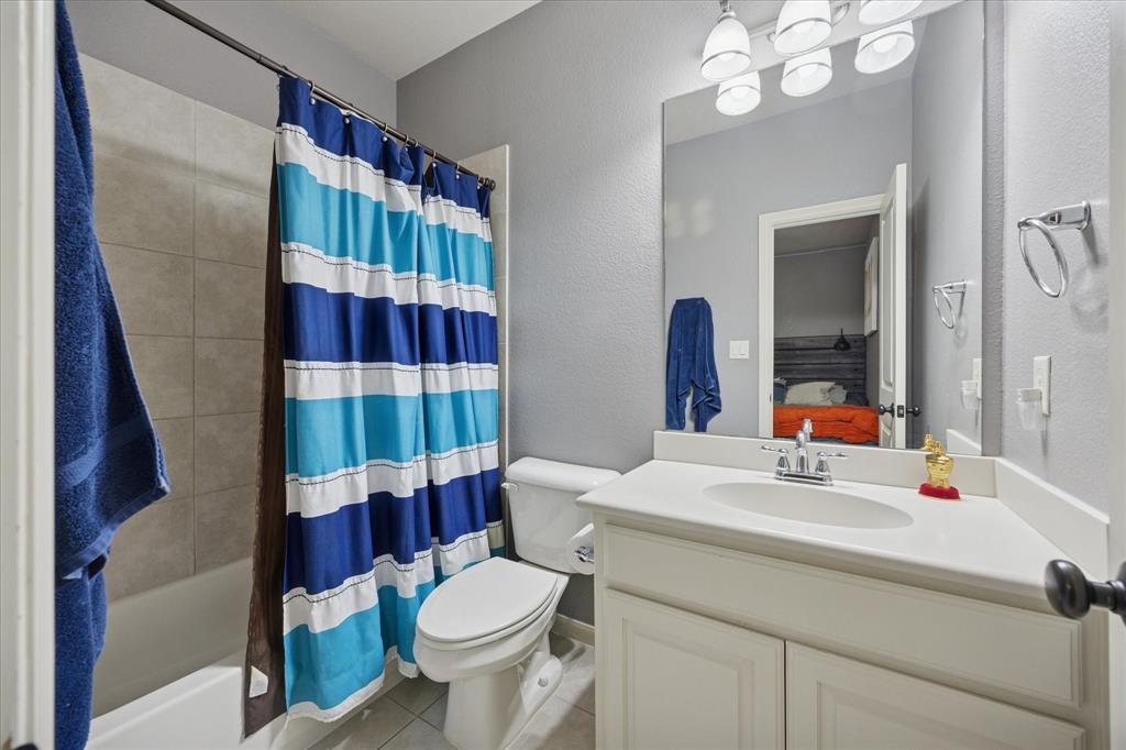 580 Butchart Drive Prosper, TX 75078 - Photo 29 of 40 Full bathroom featuring tile patterned floors, toilet, vanity, ensuite bath, and shower / bath combo with shower curtain
