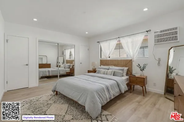 a bedroom with a bed and a couch