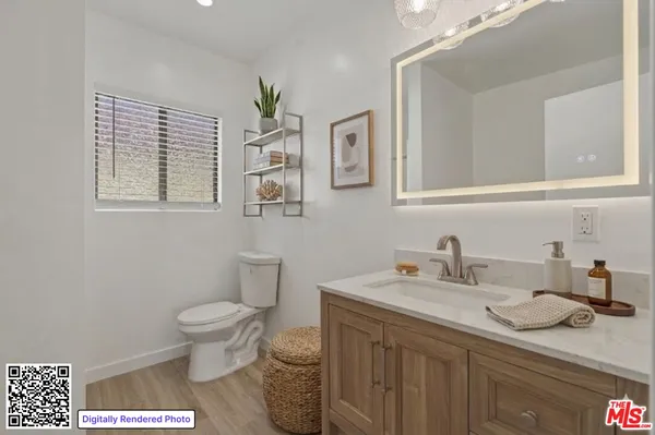 a bathroom with a sink toilet and vanity