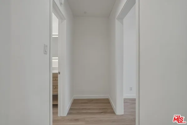 a view of a hallway with wooden floor