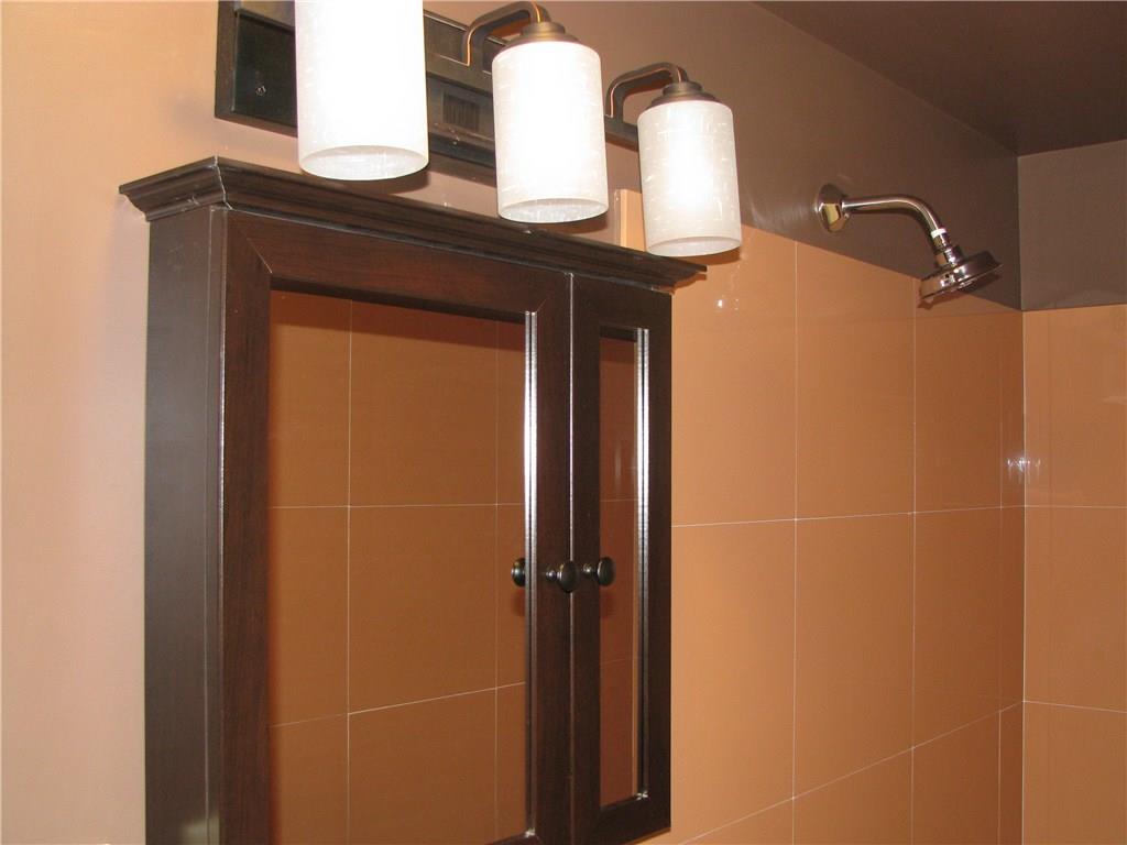 1101 Isabella Road Connellsville, PA 15425 - Photo 14 of 25 New lighting and medicine chest give this bathroom a modern look.