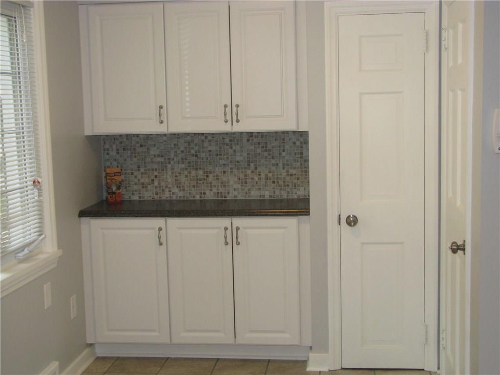 1101 Isabella Road Connellsville, PA 15425 - Photo 6 of 25 Kitchen features lots of natural light, new cabinets, and ceramic tile backsplash and flooring, as well as a built in pantry.