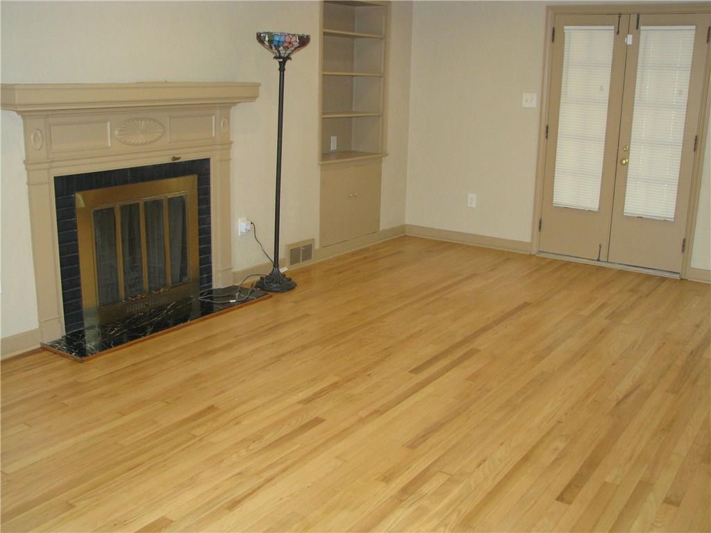 1101 Isabella Road Connellsville, PA 15425 - Photo 10 of 25 Newly refinished white oak floors and a wood burning fireplace make this living room feel warm.