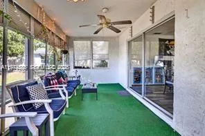 a view of a big room with furniture and floor to ceiling window