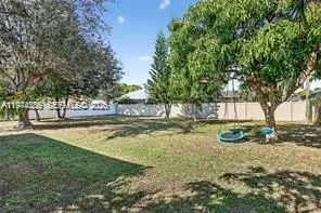 a view of a backyard with large trees