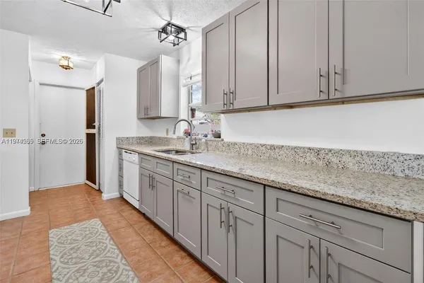 a kitchen with sink and cabinets