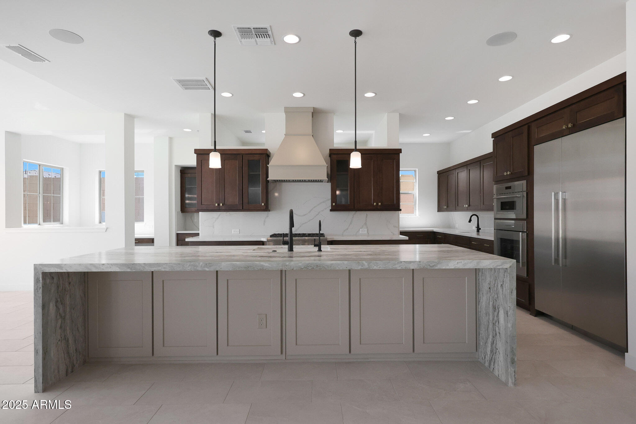 20775 West Rattler Road Buckeye, AZ 85396 - Photo 14 of 90 a large kitchen with kitchen island a sink stainless steel appliances and a counter top