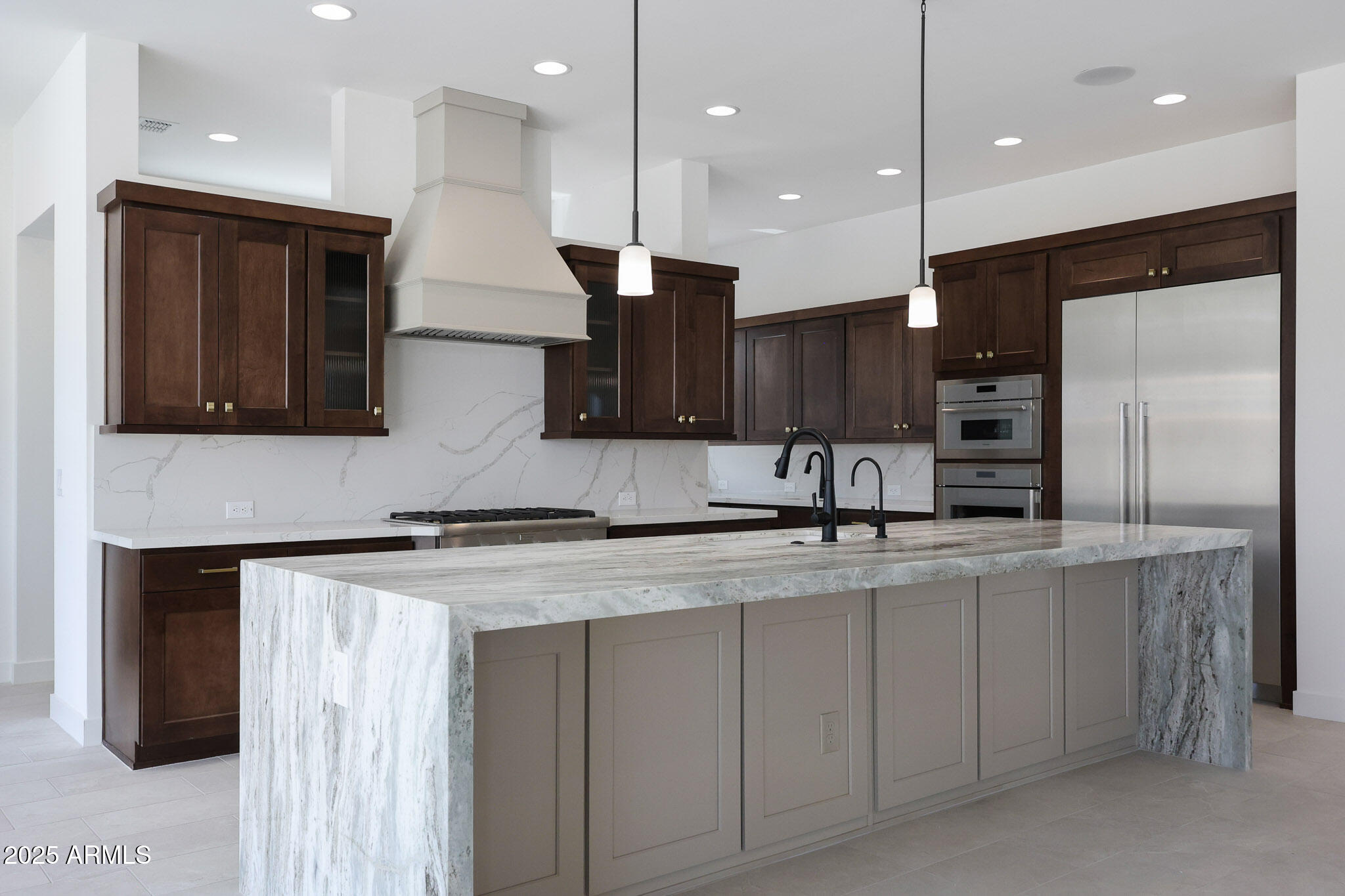20775 West Rattler Road Buckeye, AZ 85396 - Photo 15 of 90 a kitchen with kitchen island a sink stainless steel appliances and cabinets
