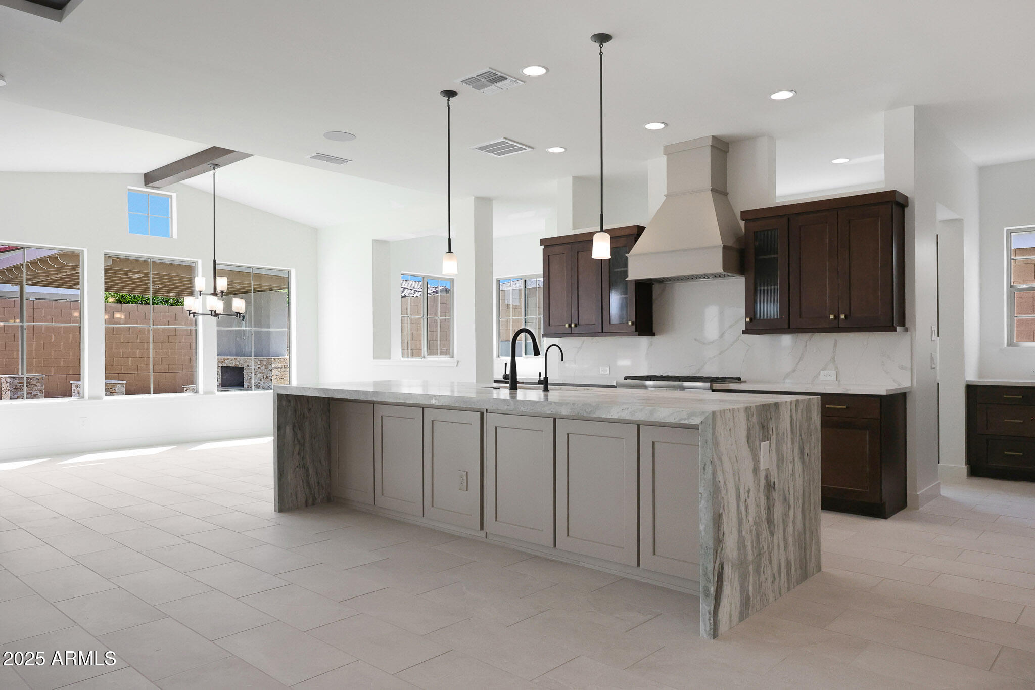 20775 West Rattler Road Buckeye, AZ 85396 - Photo 16 of 90 a large kitchen with kitchen island granite countertop a large counter top stainless steel appliances and cabinets